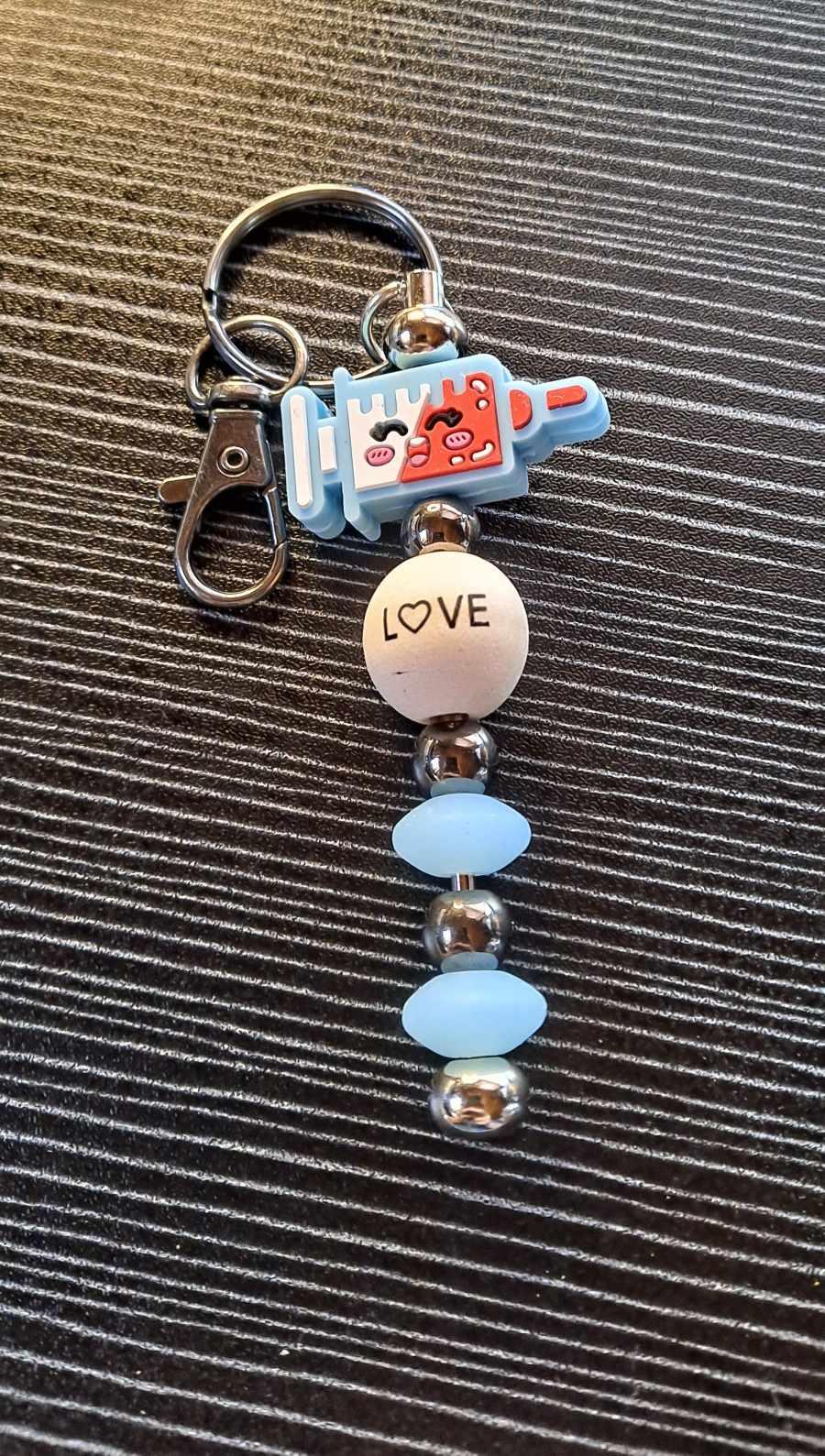 Happy Needle nursing focal love bead keychain