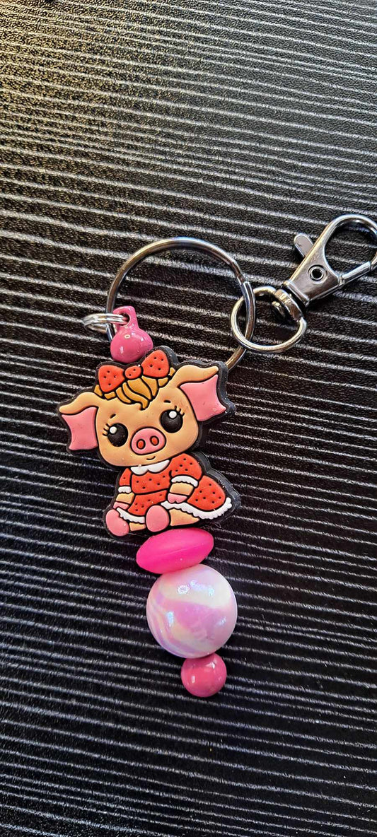 Penelope Pig red dress focal pink swirl bead keychain